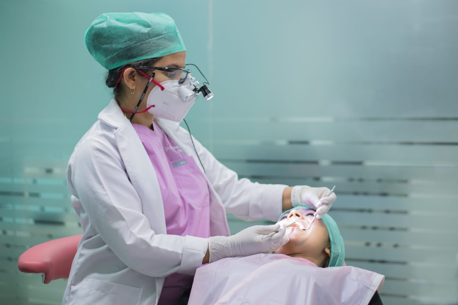 Dr. Shruthi performing a dental treatment at Smiles By Dr.Shruthi